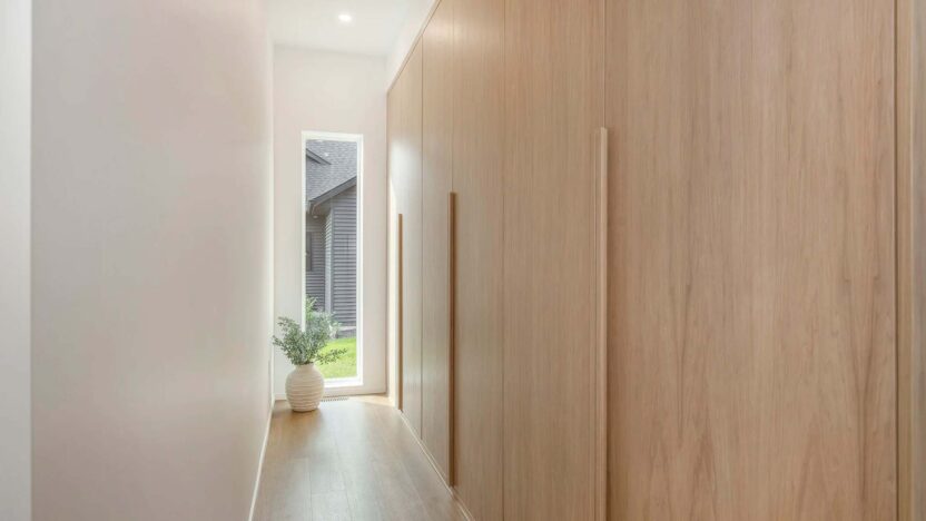 Luxury walkway of a new home featuring light wood panels
