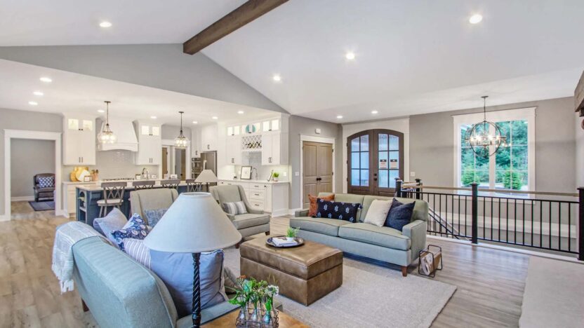Open space living room concept connecting to a modern kitchen and stairway