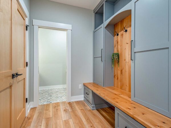 Modern mudroom with vibrant red oak wood and blue accents