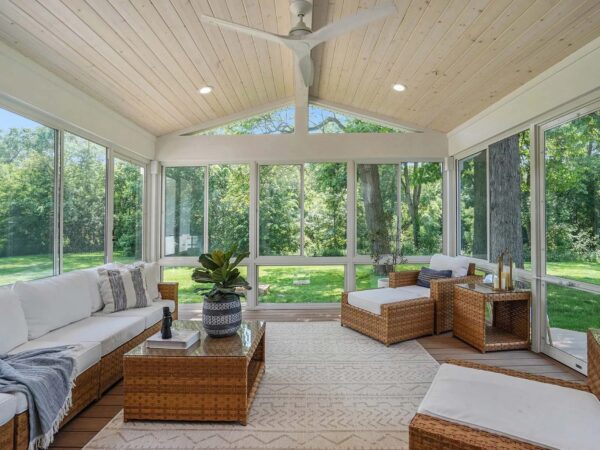 Large newly built sunroom with a fan and all window walls