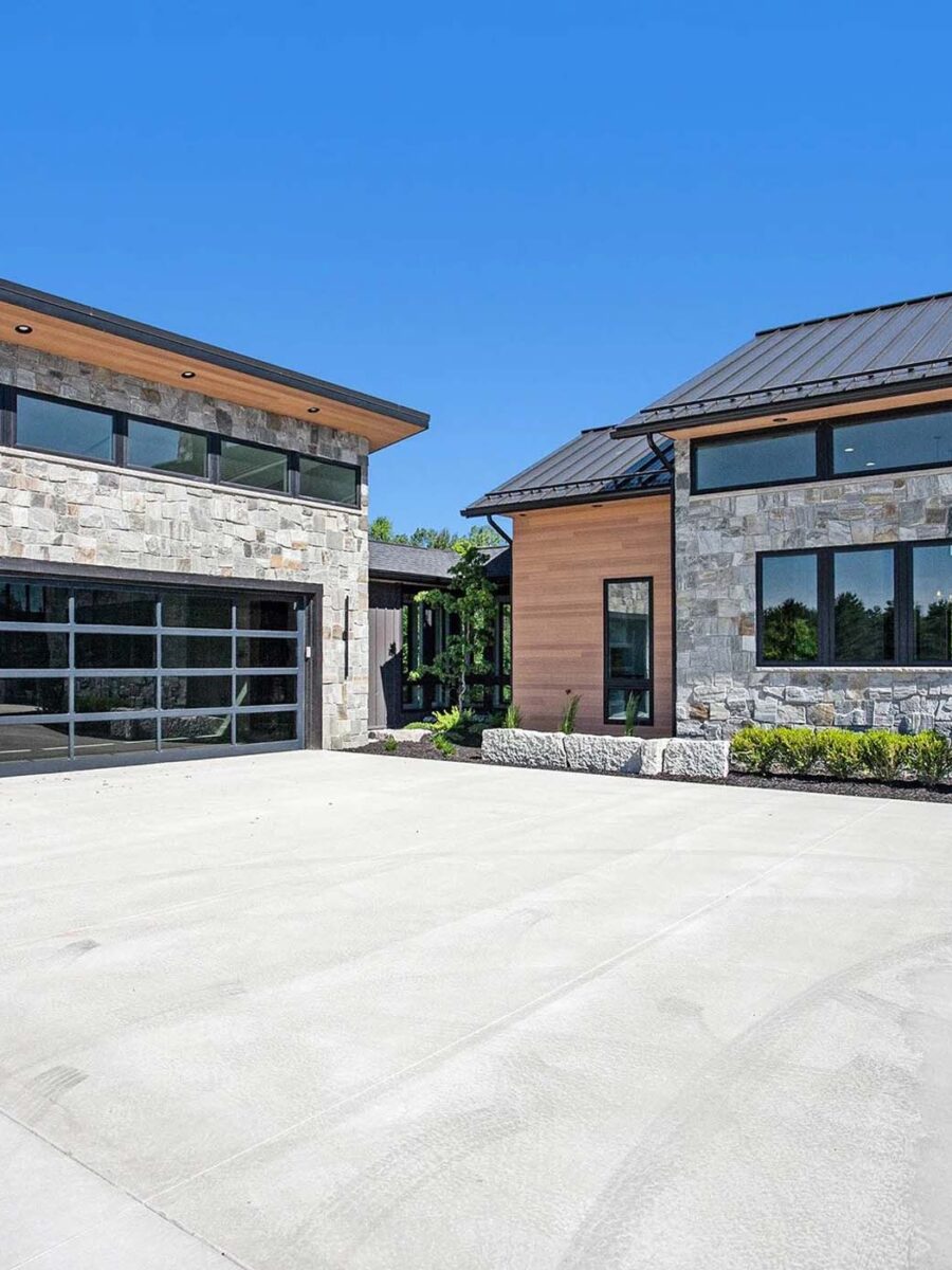 Modern luxury industrial home with grey stone and warm oak accents