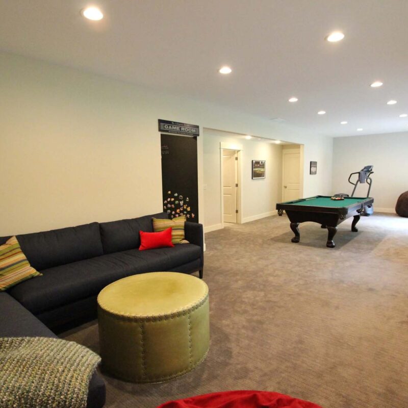 Huge basement remodel featuring a lush couch sectional and pool table