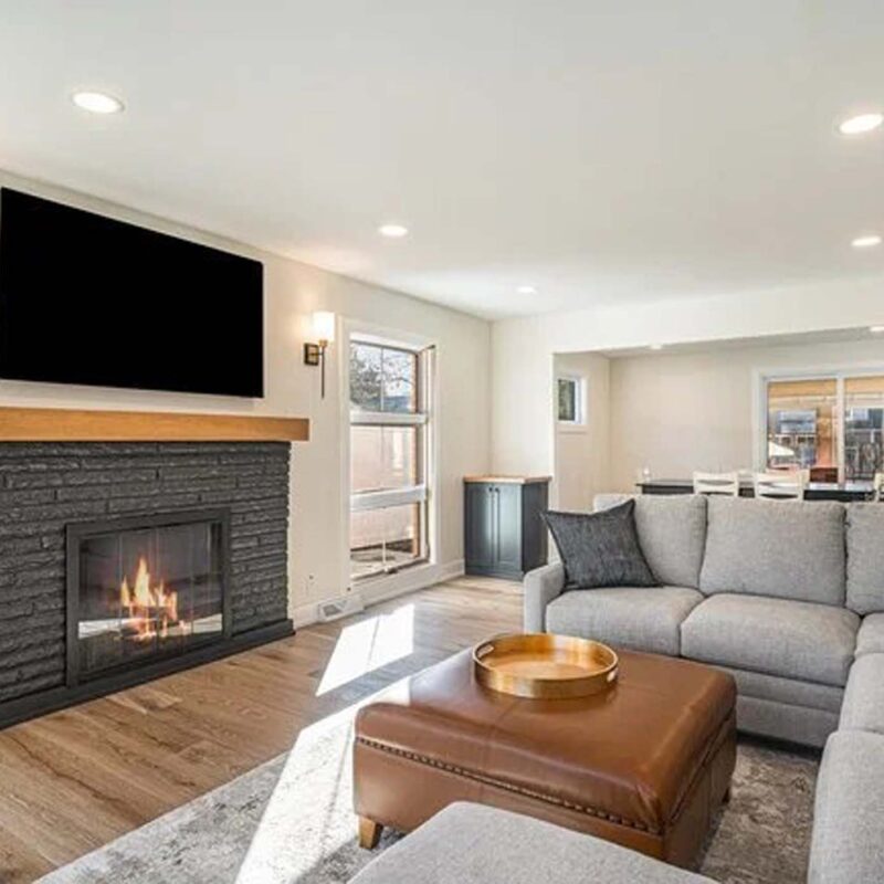 Simple modern living room with a custom built fireplace and tv stand