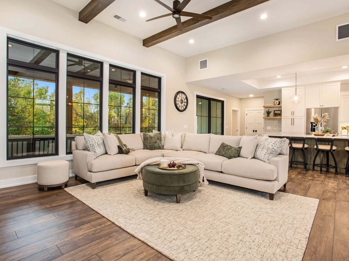 Luxury living room with a large grey sectional and green coffee table