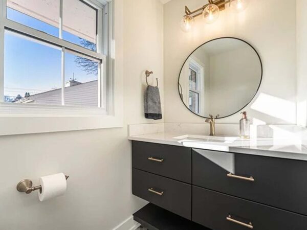 Modern compact bathroom remodel with custom black cabinetry